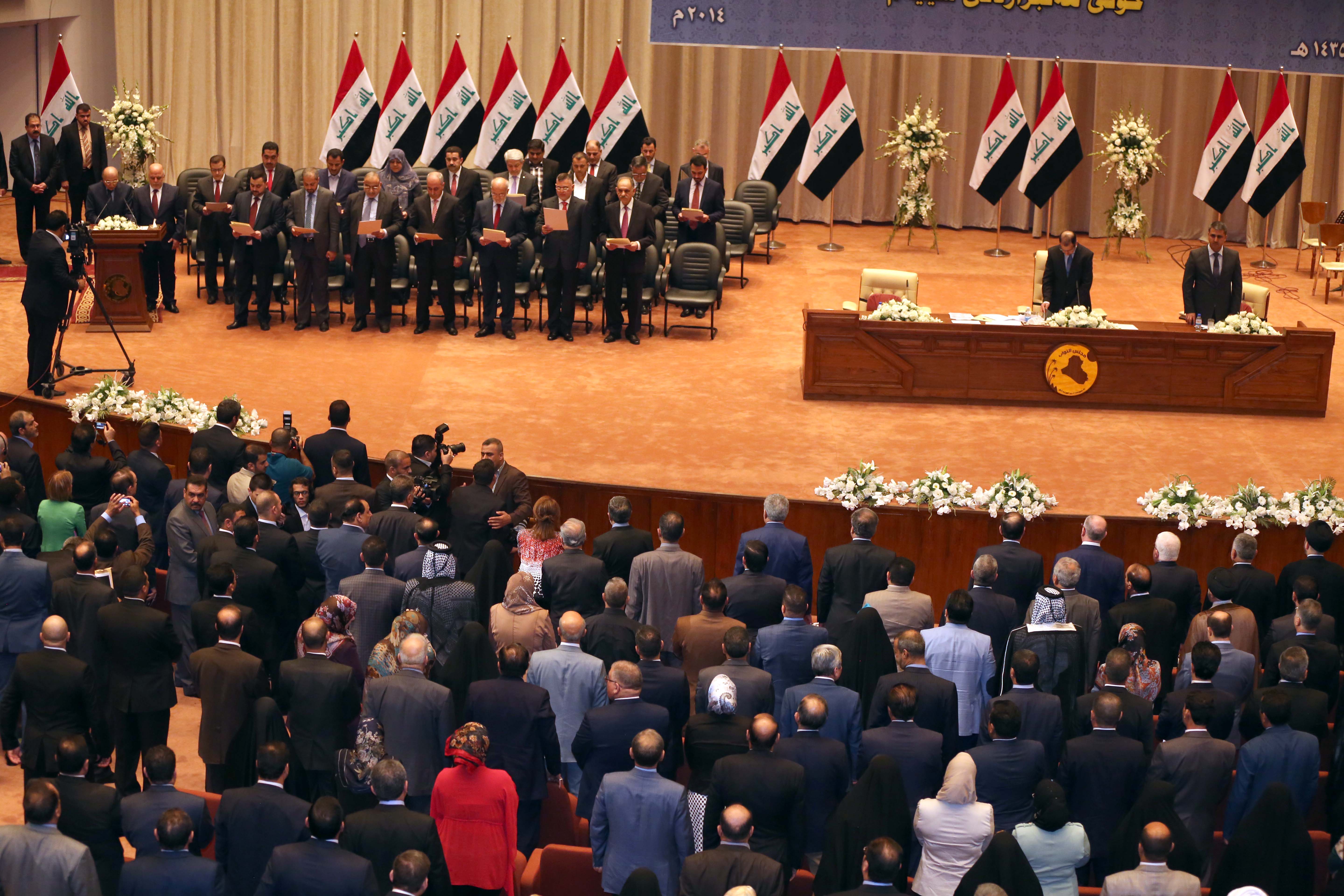 The new Iraqi government is seen during a swearing in ceremony in Baghdad, Iraq, Monday, Sept. 8, 2014. Iraq's parliament officially named Haider al-Abadi the country's new prime minister late Monday and approved most of the candidates put forward for his Cabinet amid mounting pressure to form an inclusive government that can collectively cap the advance of Sunni militants. (AP Photo/Karim Kadim)